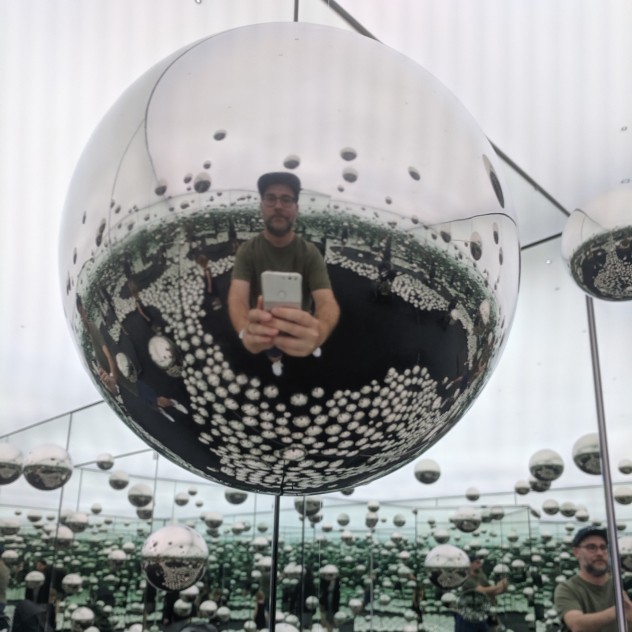 Wes taking a selfie in a Yayoi Kusama mirror exhibit.