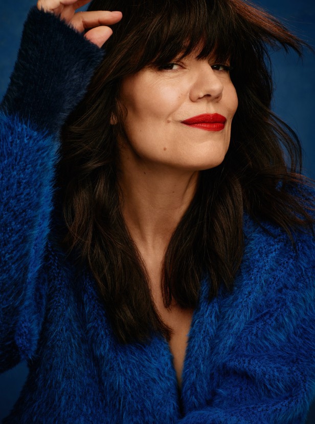 Jodi Urichuk posing for the camera to show off her Fall makeup look which features a bold red lip.