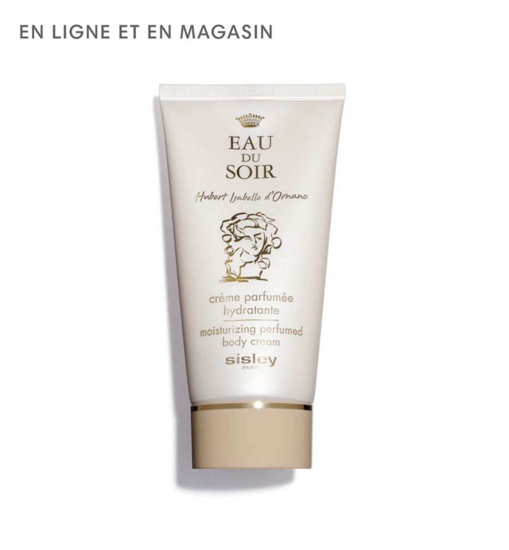 Une boîte brune à côté d'un flacon de parfum transparent