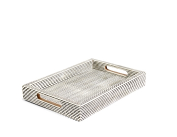 Holt Renfrew image of MELA ARTISANS. Artisan-made large decorative tray in pinstripe. $195. SHOP MELA ARTISANS