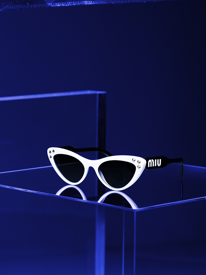 Holt Renfrew image of Miu Miu Narrow cat eye sunglasses with crystal embellishment in white and black. $480.