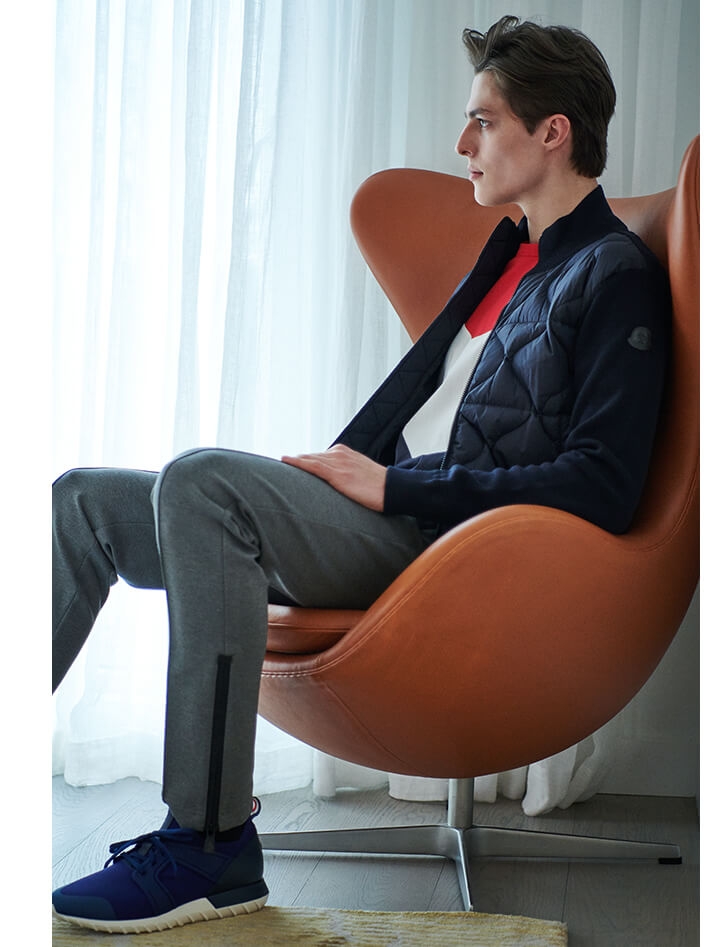Holt Renfrew image of MONCLER Down Sweater Jacket. $990. Kith Colourblock T-Shirt. $305. Emilien Neoprene Sneakers. $510. MONCLER GRENOBLE Pintucked Jogger Pants. $800.