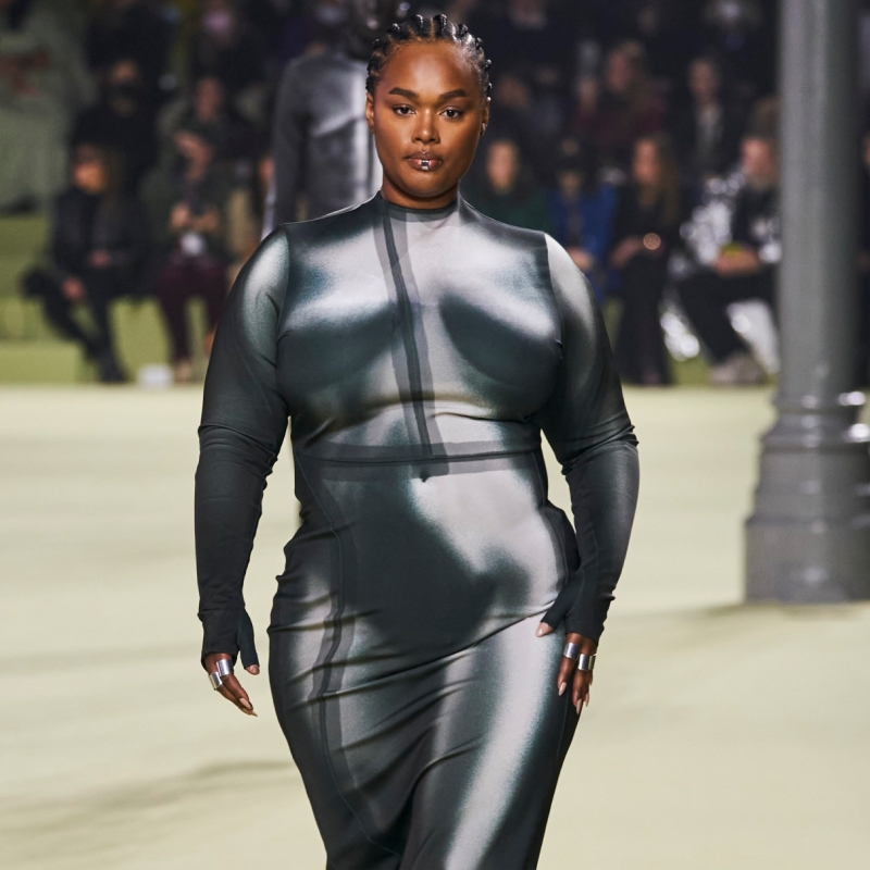 A model wearing a bodycon dress with a trompe l’oeil print of a body on it.