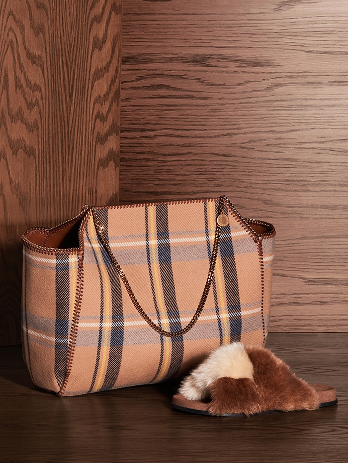 Holt Renfrew Image of STELLA MCCARTNEY wool and alter-nappa Falabella reversible tote in camel check. $1975. Faux fur flat sandal in sugar cane. $520. 