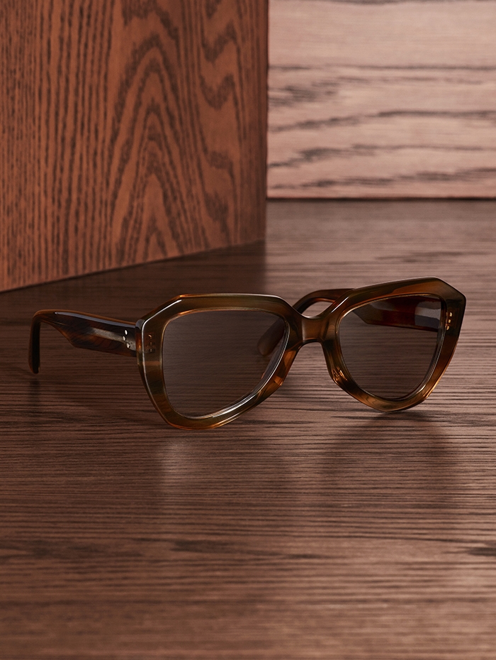 Holt Renfrew Image of CÉLINE sunglasses in blue and brown Havana stripe acetate frame with photochromic lenses that darken in the sun. $620. 