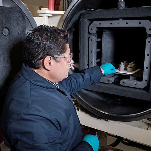 Kennametal employee with machine and additive manufactured components