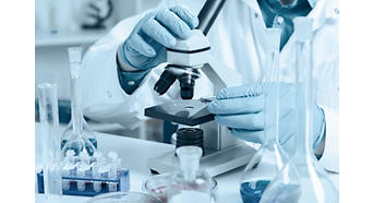 Researcher in Lab with Microscope