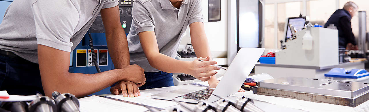 Two Engineers Using CAD Program Software on Laptop Banner