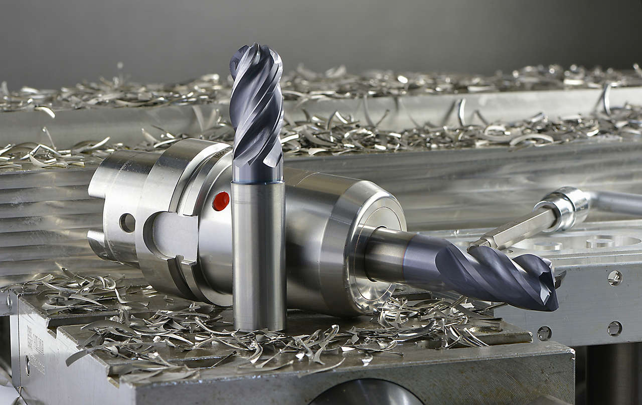 WIDIA WCE4 solid end mill, WCE4 in tool holder, and metal chips on a metal workpiece