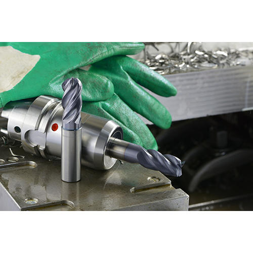 WIDIA WCE4 solid end mill, WCE4 in tool holder, gloves, and metal chips on a metal workpiece