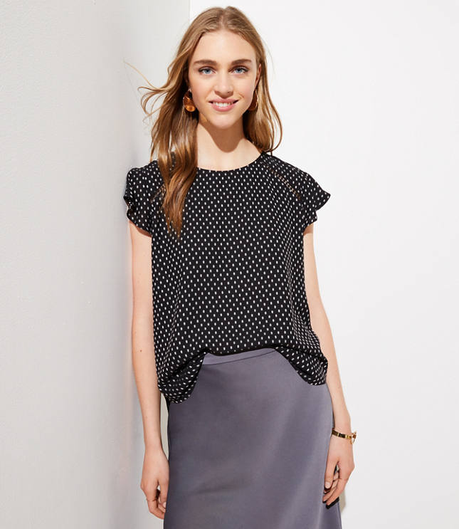 This polished top is a spot on flirt - with flutter sleeves, delicate cutouts and back ties. Round neck. Cap sleeves. V-back with ties. Hi-lo shirttail hem.