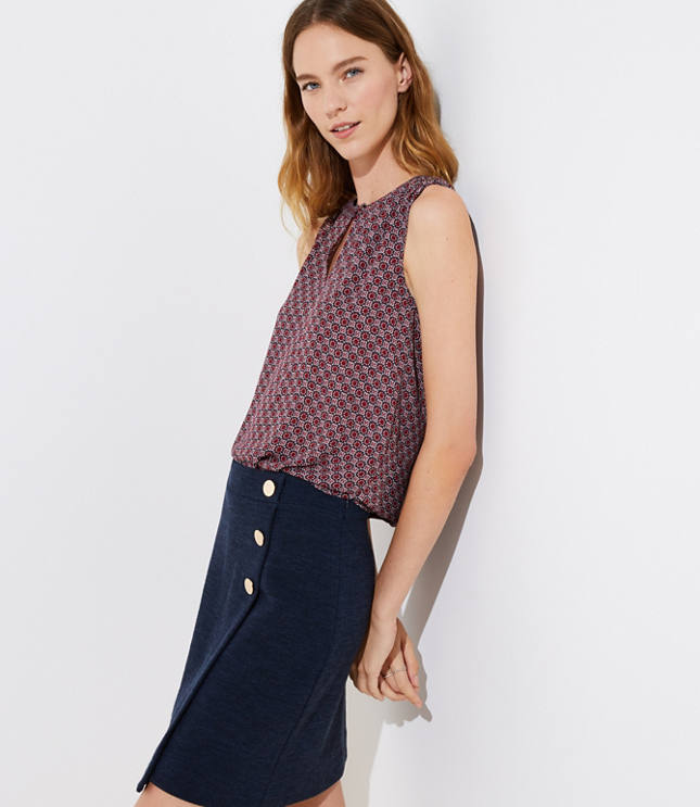 Smocked shoulders and a keyhole neckline start this shell on a femme and flattering note. Round neck with button keyhole. Sleeveless. Shirttail hem.