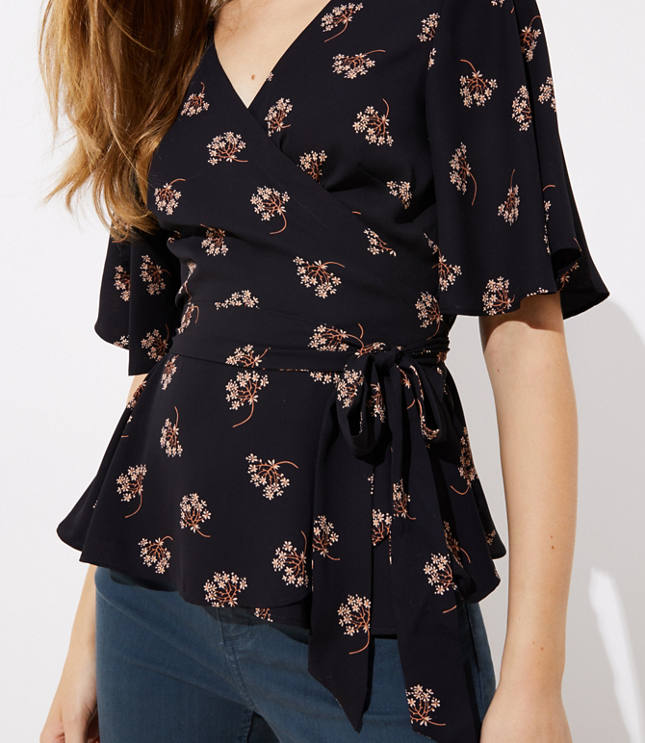 This romantic wrap blouse proves the flattering appeal of a tied waist (with a hint of flair from its hem, too). V-neck. Flutter half sleeves. Waist ties.