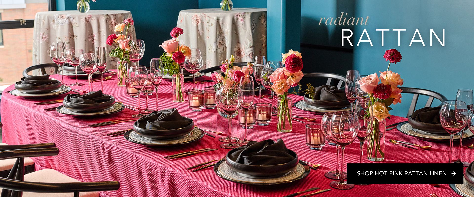 High-contrast tablescape showcasing the intricate texture of hot pink rattan linen against black stoneware.
