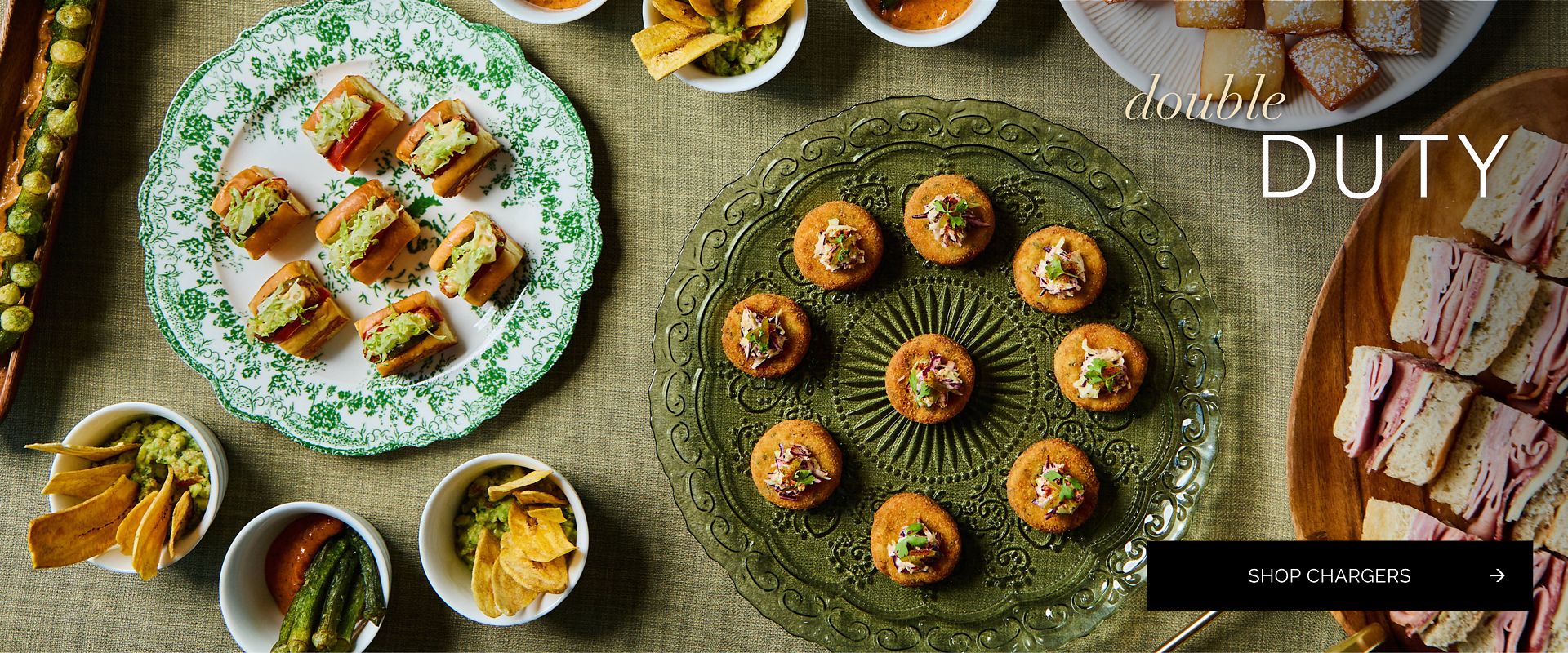 Green pressed-glass and floral transferware chargers used as passing platters for sliders, crab cakes, and hors d’oeuvres by Party Rental Ltd.