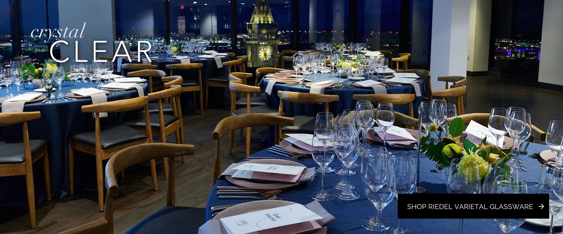 Gala setup at the State Room in Boston featuring a navy linens, dark wood chairs, and varietal wine glasses from Party Rental Ltd.