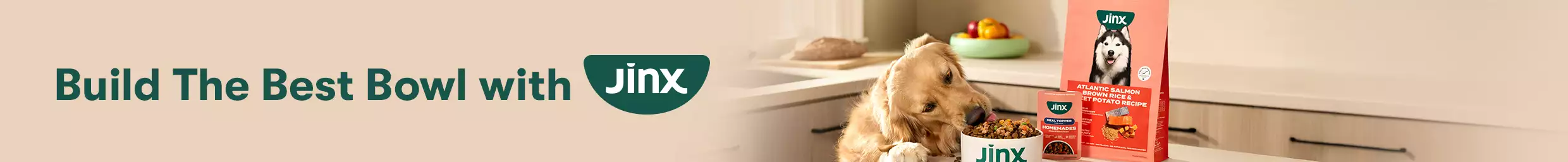 Dog eating Jinx food out of a bowl on the counter next to Jinx dog food product