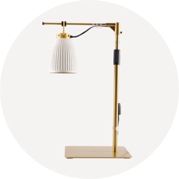 Cream and gold light fixture with glass lamp