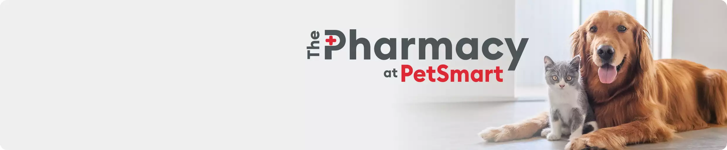 The Pharmacy at PetSmart logo and a dog and cat laying together