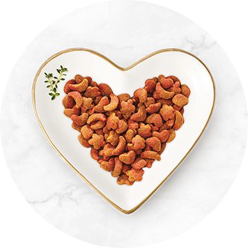 Dry food in heart shaped bowl