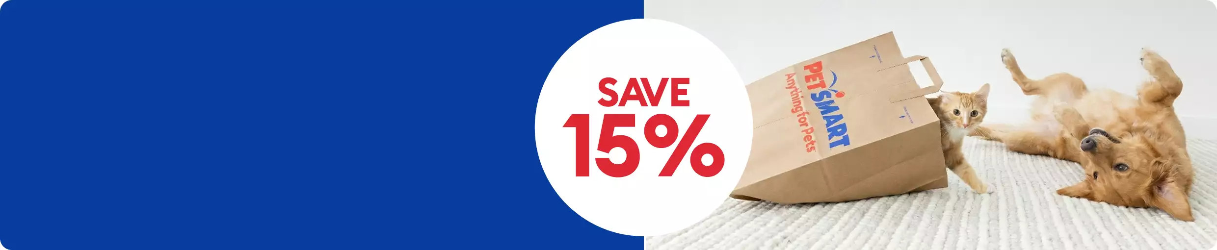 Dog & cat playing beside PetSmart paper bag with ‘Save 15%’ callout