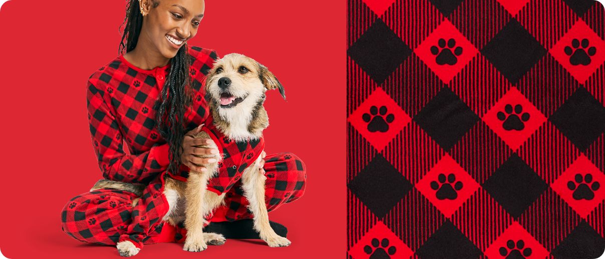 Pet parent with dog in matching buffalo plaid pajamas