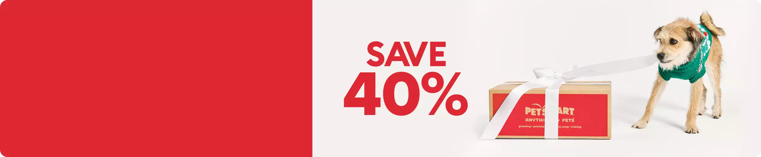 Save 40% callout and a dog wearing a green sweater, pulling at a ribbon tied around a PetSmart shipping box