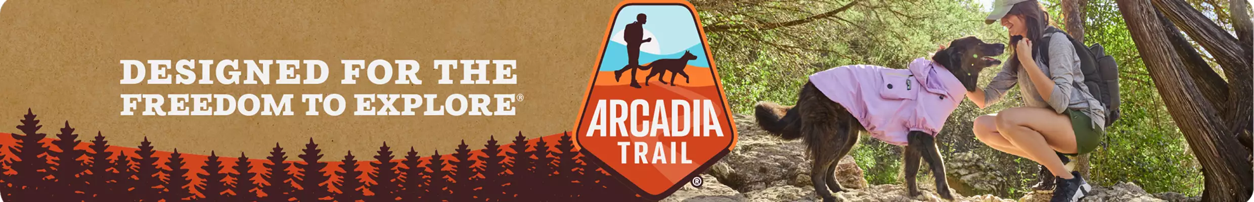 Designed for the Freedom to Explore with illustrated trees, Arcadia Trail logo & woman petting her dog in an Arcadia Trail coat on a hike