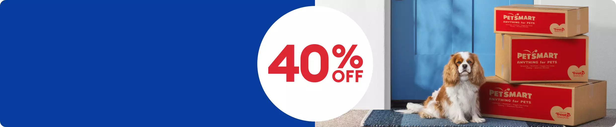 Save 40% on first Autoship order callout and a brown-and-white Cocker spaniel sitting next to three PetSmart delivery boxes.