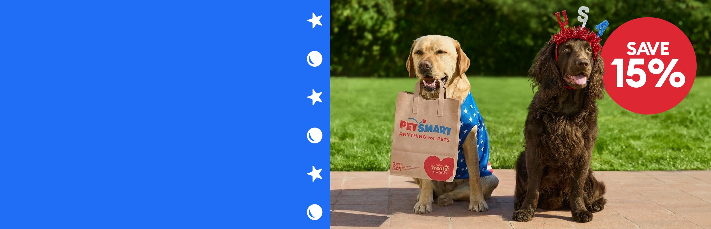 Save 15% callout and two dogs sitting outside, one holding a PetSmart shopping bag, wearing patriotic accessories