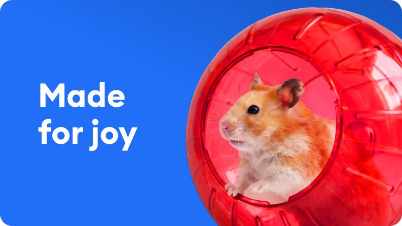 A hamster sitting inside a red exercise wheel and text that reads, made for joy