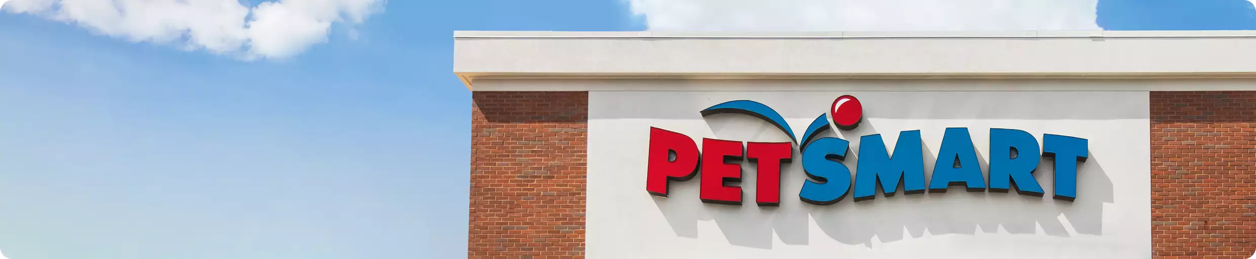 PetSmart storefront and a blue sky with scattered clouds