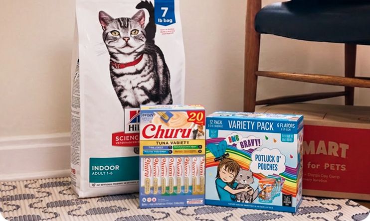 Dog of Hillis Science Diet cat food, Churu variety pack, Weruva variety pack next to PetSmart box