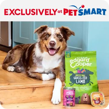 Dog laying next to Edgard & Cooper products and an Exclusively at PetSmart callout