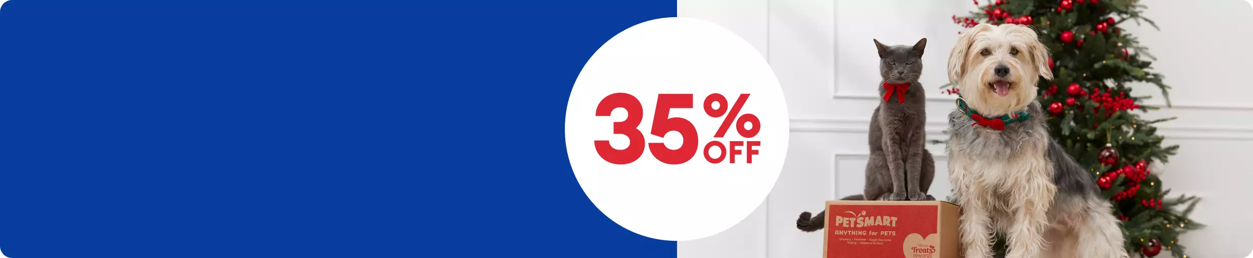 35% off callout & a cat sitting on a PetSmart box next to a dog and a Christmas tree