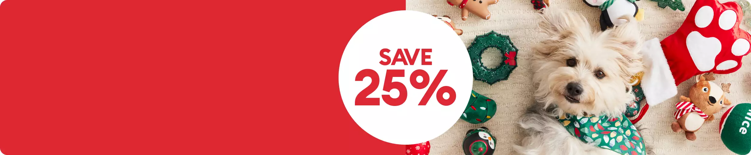 Save 25% callout and a white dog laying on the floor in a pile of holiday toys