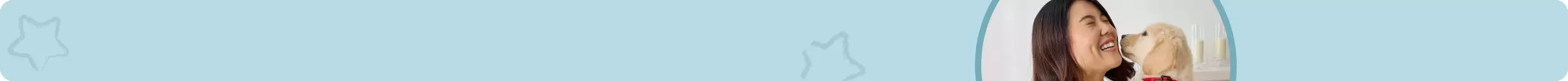 Closeup of woman & golden retriever puppy nuzzling