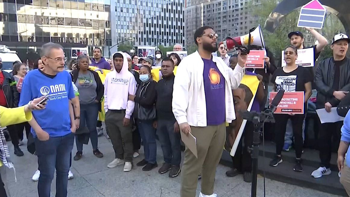 Advocates and the family of Kawaski Trawick are pictured during a rally.