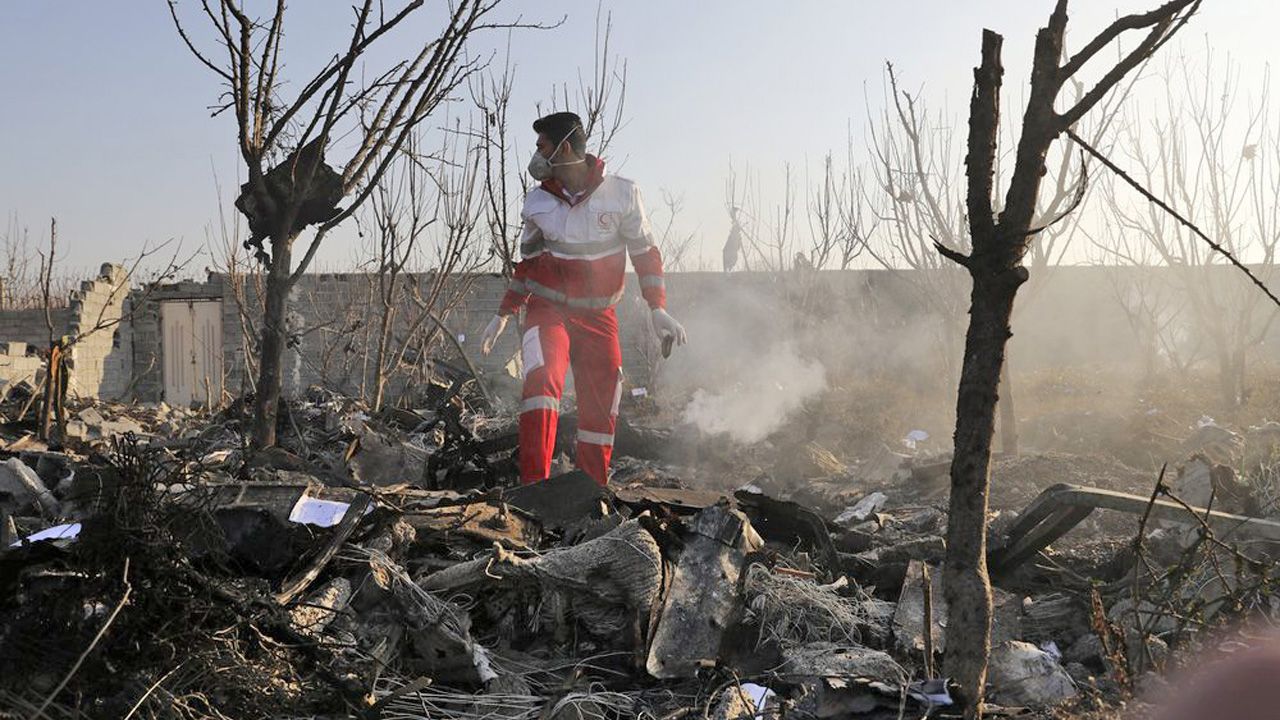 A rescue worker searches the scene where an Ukrainian plane crashed in Shahedshahr, southwest of the capital Tehran, Iran, Wednesday, Jan. 8, 2020. A Ukrainian airplane carrying 176 people crashed on Wednesday shortly after takeoff from Tehran's main airport, killing all onboard. (AP Photo/Ebrahim Noroozi)