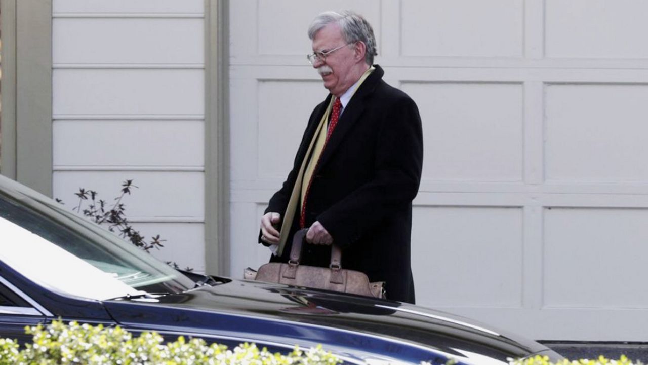 Former National security adviser John Bolton leaves his home in Bethesda, Md., Tuesday, Jan. 28, 2020. President Donald Trump's legal team is raising a broad-based attack on the impeachment case against him even as it mostly brushes past allegations in a new book that could undercut a key defense argument at the Senate trial. Former national security adviser John Bolton writes in a manuscript that Trump wanted to withhold military aid from Ukraine until it committed to helping with investigations into Democratic rival Joe Biden. (AP Photo/Luis M. Alvarez)