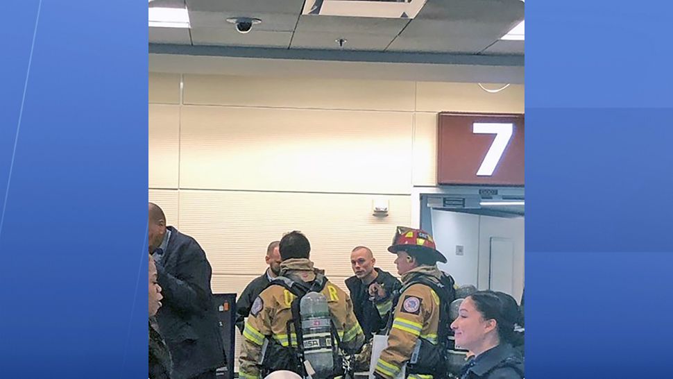 Emergency workers meet a JetBlue plane shortly after it returned to Orlando International Airport on Wednesday. Fumes were reported in the cockpit. (Courtesy of Glenton Gilzean)