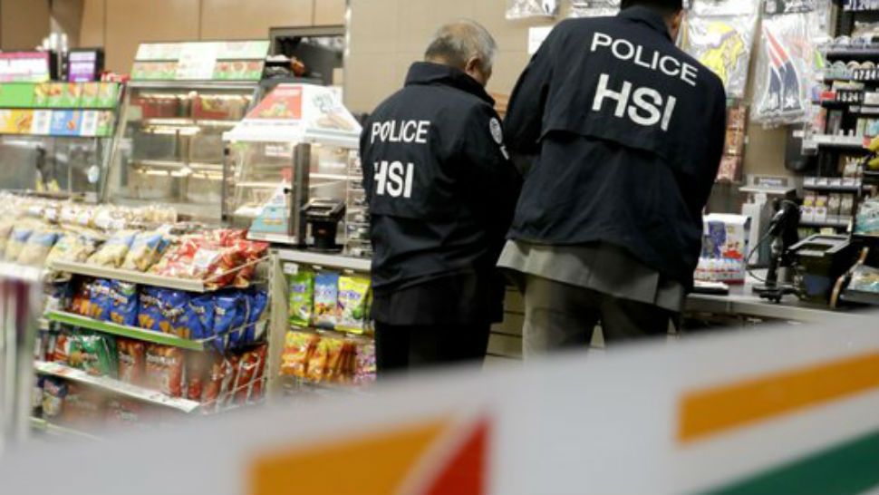 U.S. Immigration and Customs Enforcement agents serve an employment audit notice at a 7-Eleven convenience store Wednesday, Jan. 10, 2018, in Los Angeles. Agents said they targeted about 100 7-Eleven stores nationwide Wednesday to open employment audits and interview workers. (AP Photo/Chris Carlson)