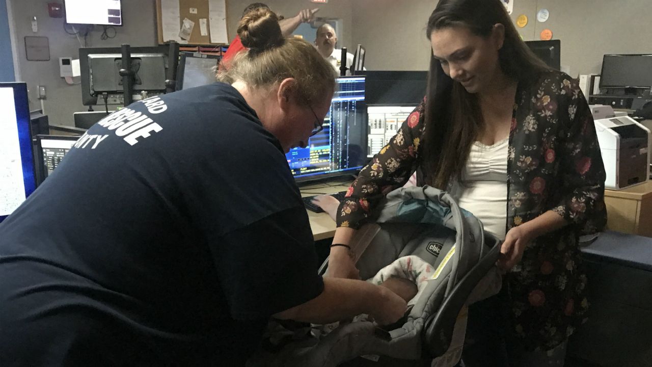 Brevard County Fire 911 dispatcher Karen Holley meets Jennifer Allen and her new son, 7-pound, 4-ounce bundle of joy Taylor, on Wednesday, a week after Taylor came into the world on Interstate 95 on the way to the hospital. Holley was on the phone with Jennifer during the delivery and kept the family calm. (Greg Pallone/Spectrum News)