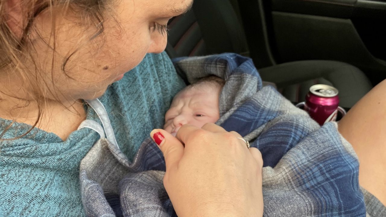 Jennifer Allen holds little Taylor after he came into the world on the way to the hospital on Interstate 95. (Courtesy of Mark Allen)