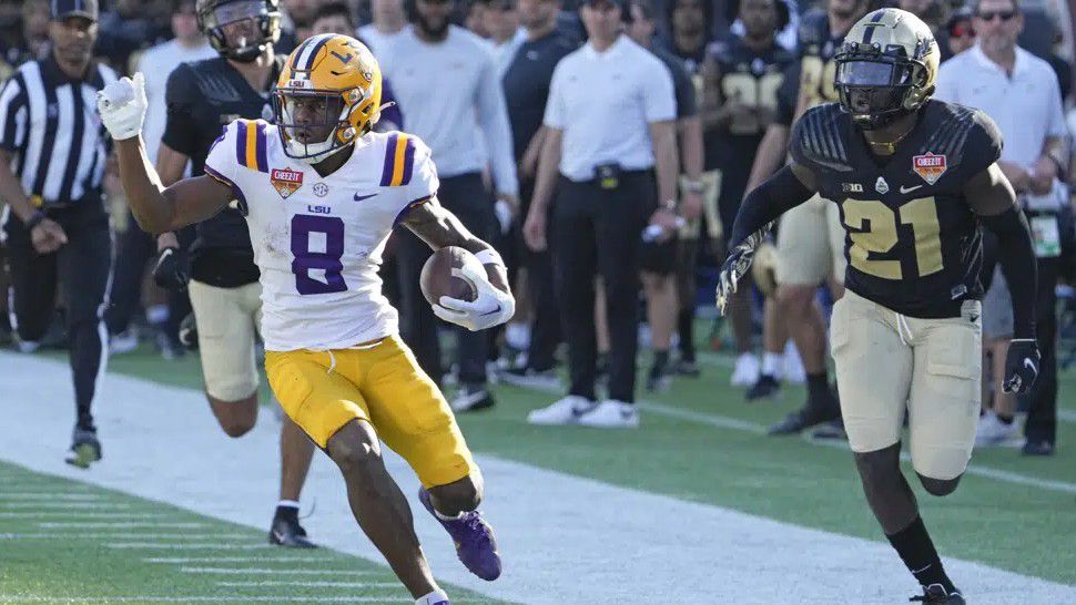 LSU wide receiver Malik Nabers (8) runs past Purdue cornerback Bryce Hampton, left, and safety Sanoussi Kane (21) on his way to a 75-yard touchdown on a pass play during the second half of the Citrus Bowl NCAA college football game Monday, Jan. 2, 2023, in Orlando, Fla. (AP Photo/John Raoux)