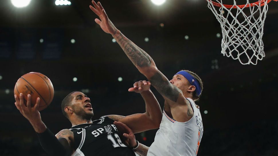 San Antonio Spurs forward LaMarcus Aldridge (12) puts up a shot against New York Knicks forward Michael Beasley (8) during the third quarter of Tuesday's game, Jan. 2, 2018. AP/Julie Jacobson