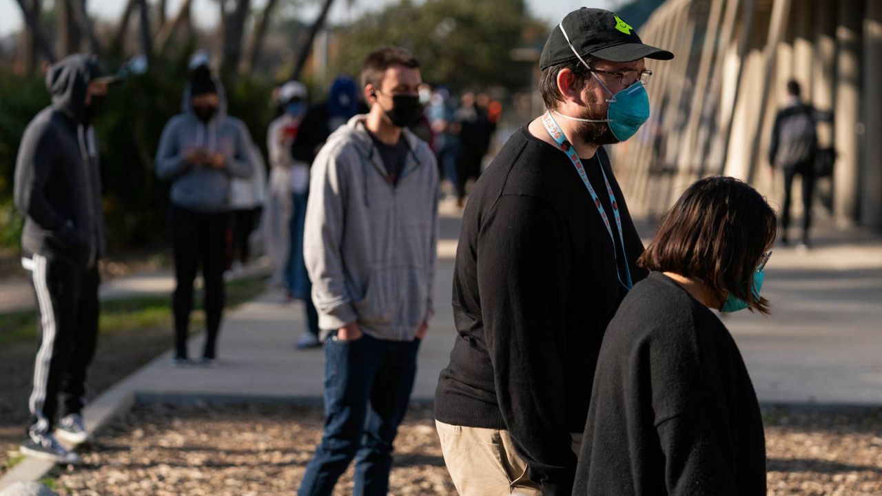 People wait in line for a COVID-19 test at a testing site operated by CORE in Los Angeles, Jan. 4, 2022. (AP Photo/Jae C. Hong)