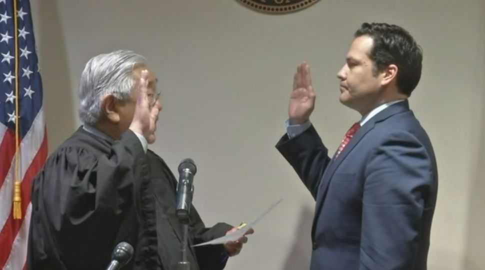 Rep. Justin Rodriguez sworn in as Precinct 2 Commissioner in San Antonio by Judge Peter Sakai January 4, 2019 (Spectrum News)
