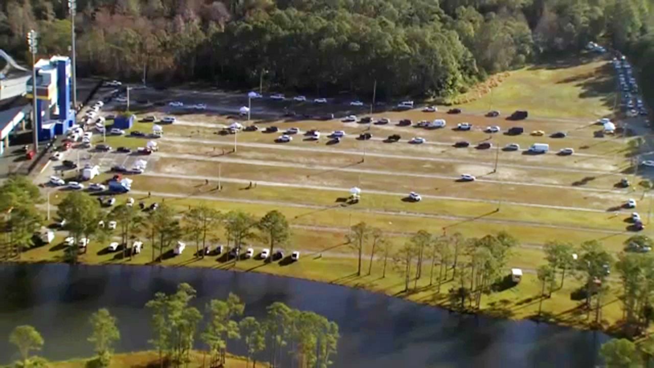 Motorists wait in line at the COVID-19 vaccination site Monday morning at Daytona Stadium. Residents were discouraged from camping out, but some said they waited since Sunday to ensure a place in line. (Sky 13)