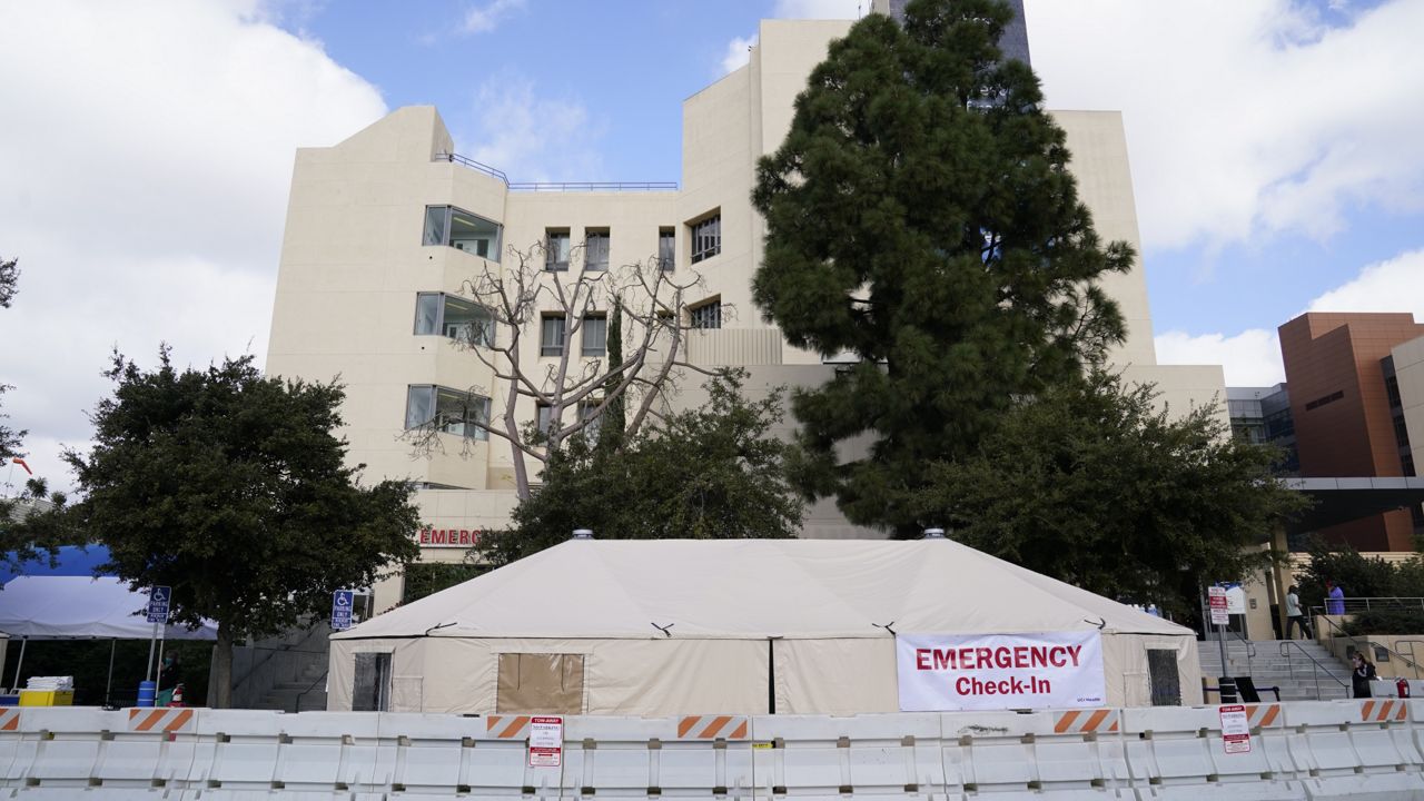 Medical tents are set up outside the emergency room at UCI Medical Center Thursday, Dec. 17, 2020, in Irvine, Calif. (AP Photo/Ashley Landis)